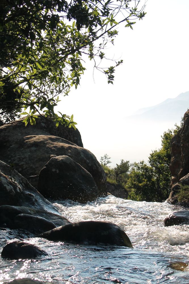 a large waterfall over a body of water