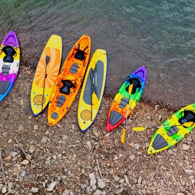 kayaks and paddle boards on shore