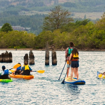 a group of people rowing a boat in the water