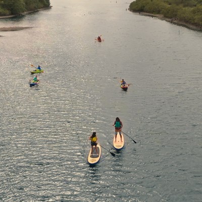 Six people in kayaks and on sups on the Columbia River